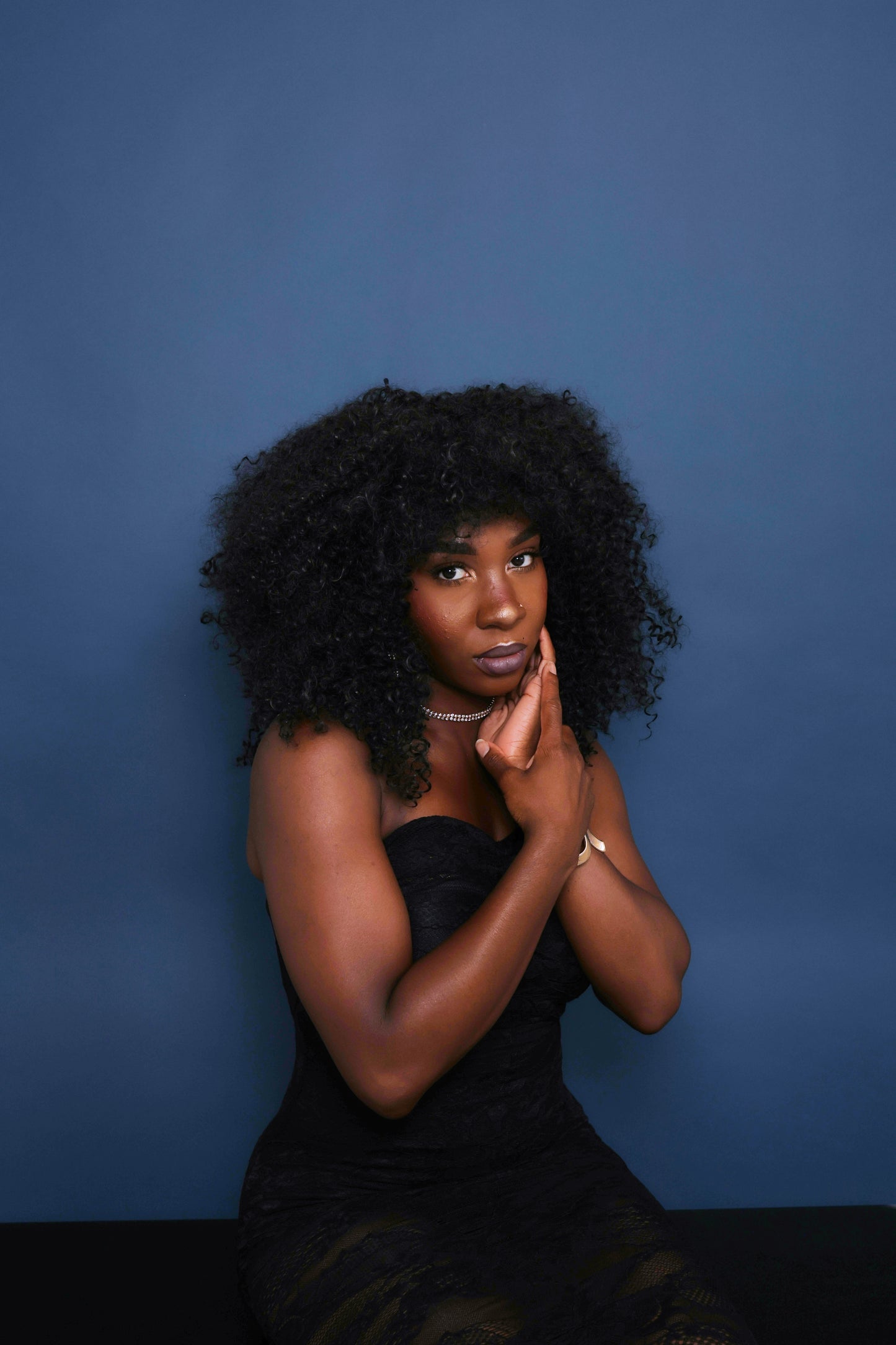 Portrait photography against a blue backdrop