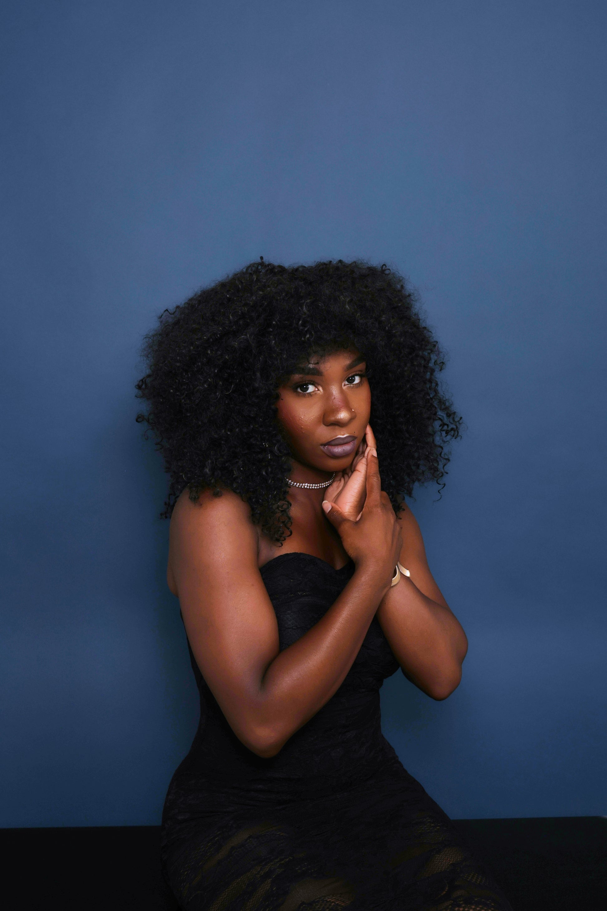 Portrait photography against a blue backdrop