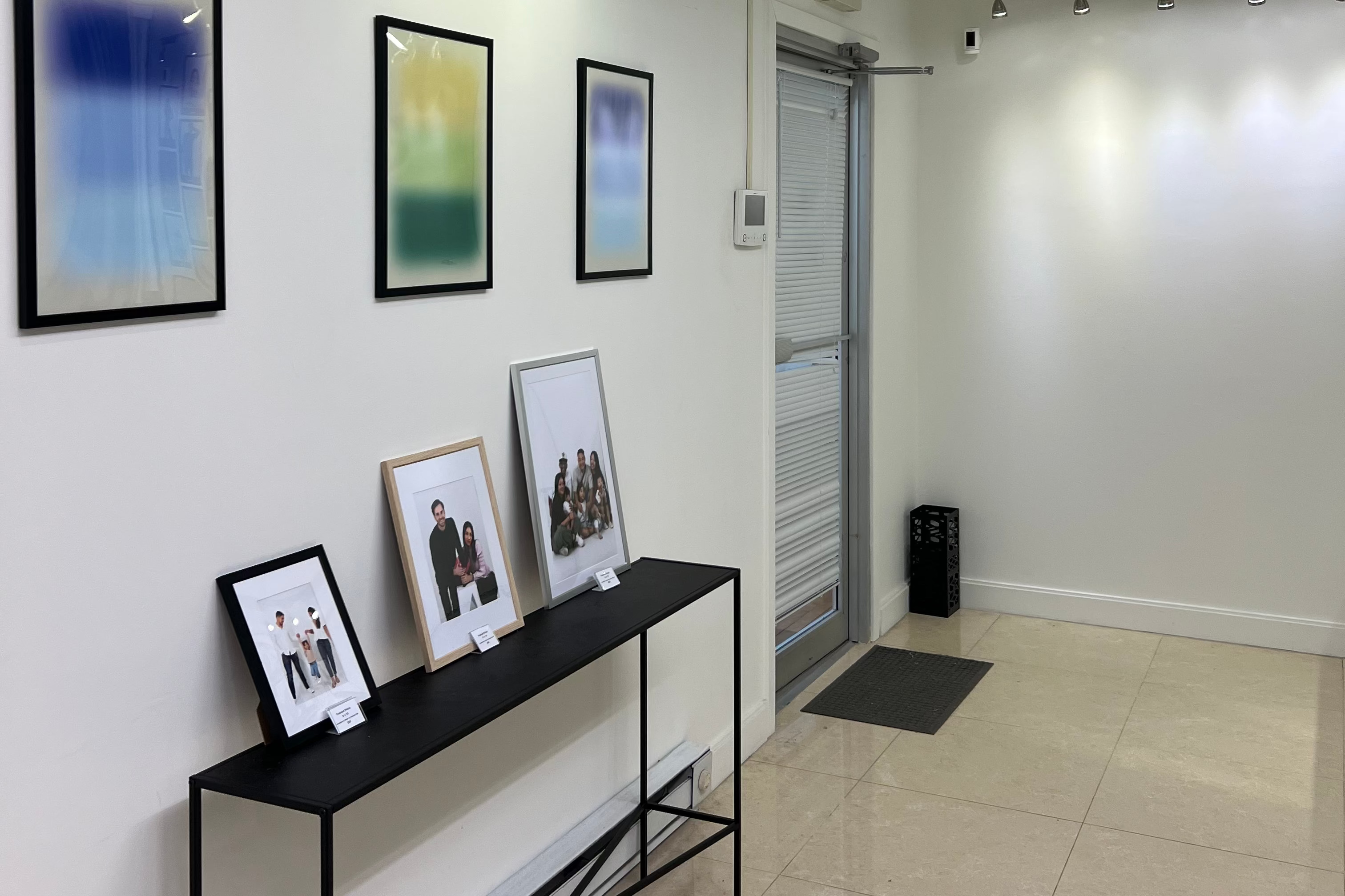 Picture of Muse Studios Boston interior including framed portrait offerings
